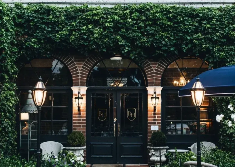 Ivy-covered entrance and brick arches at Berida Hotel in Bowral